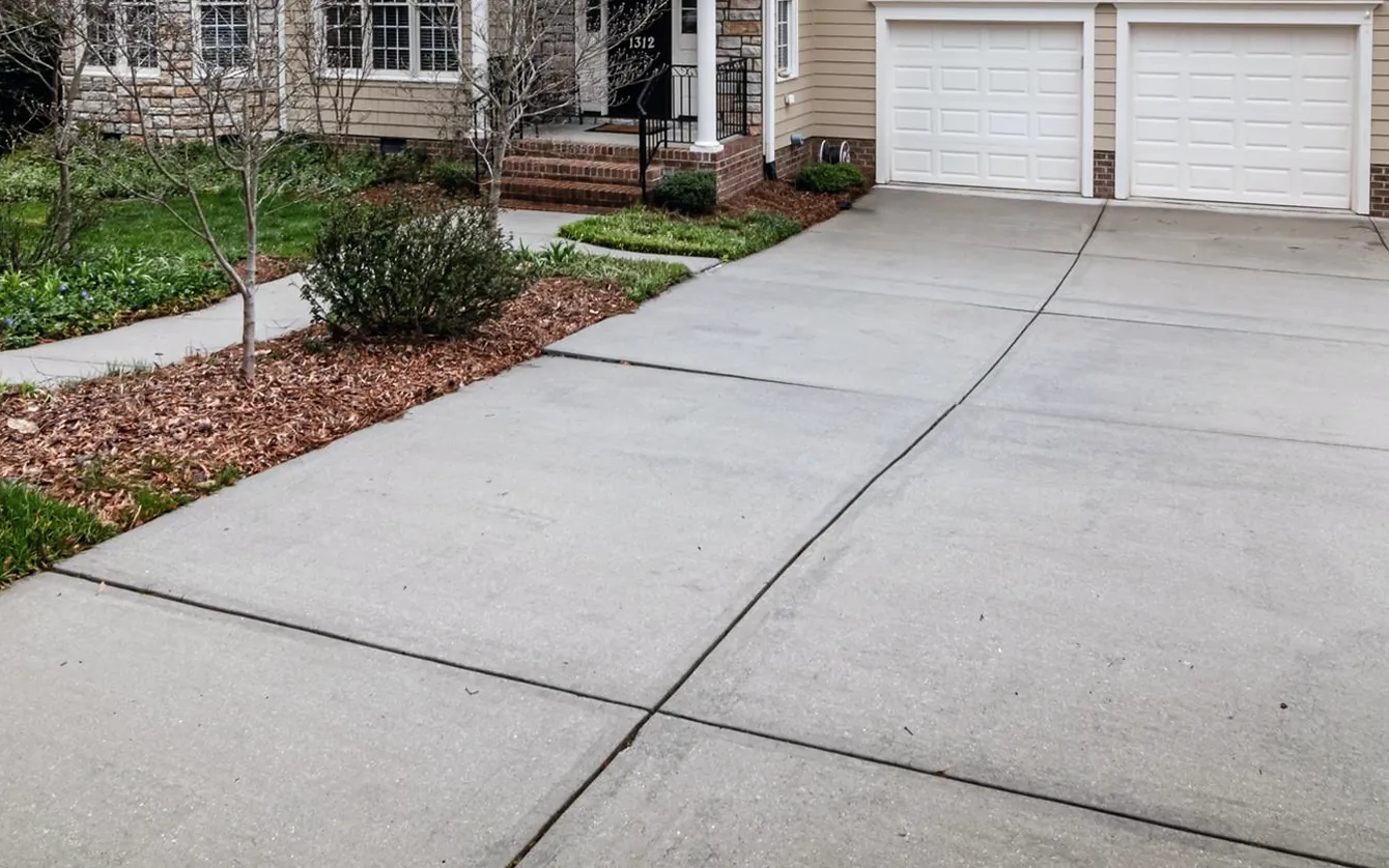 Concrete driveway shown weathered and then clean — after