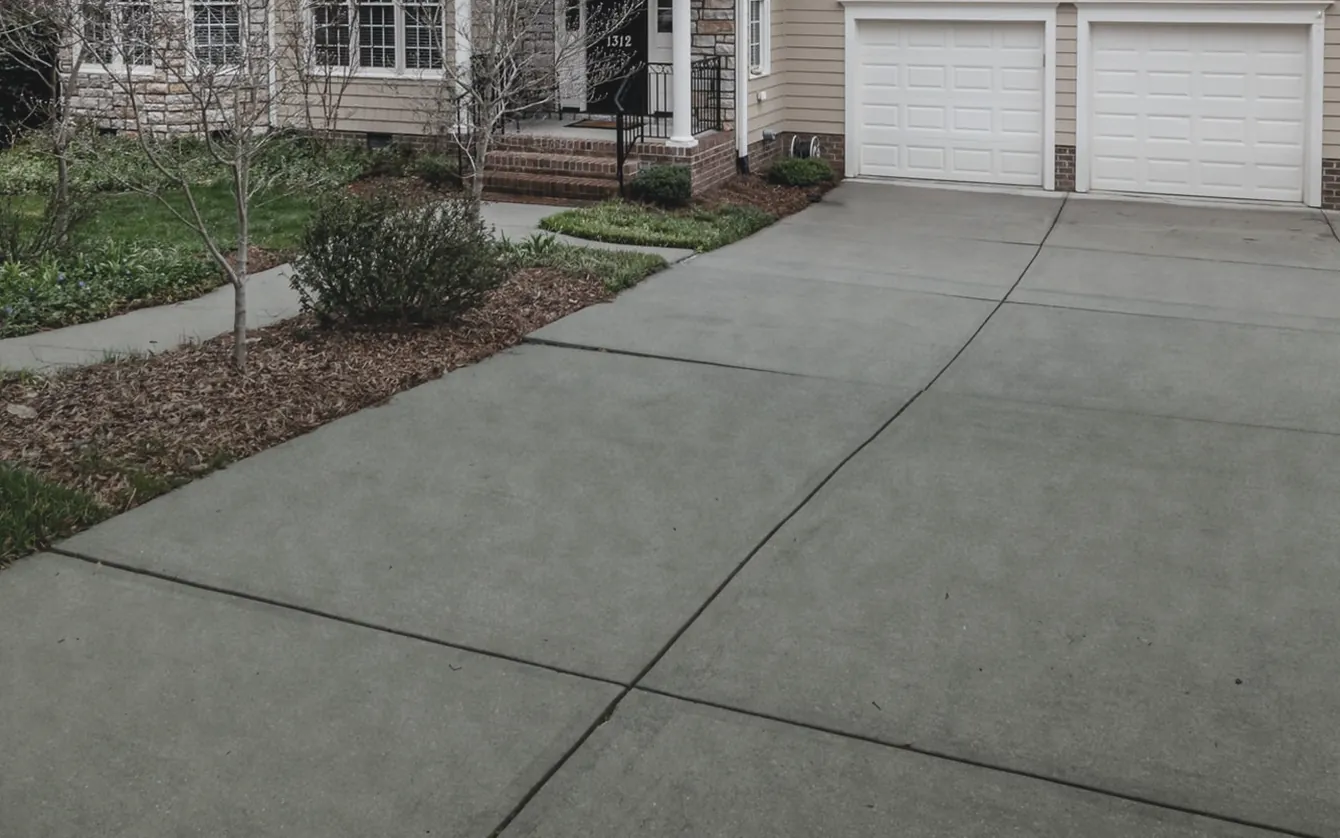 Concrete driveway shown weathered and then clean — before