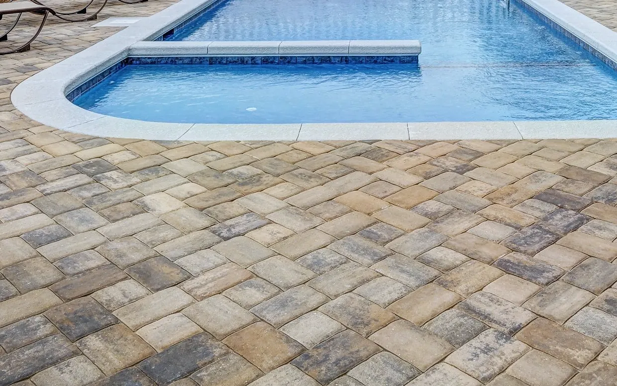Paver pool surround shown weathered and then clean — after