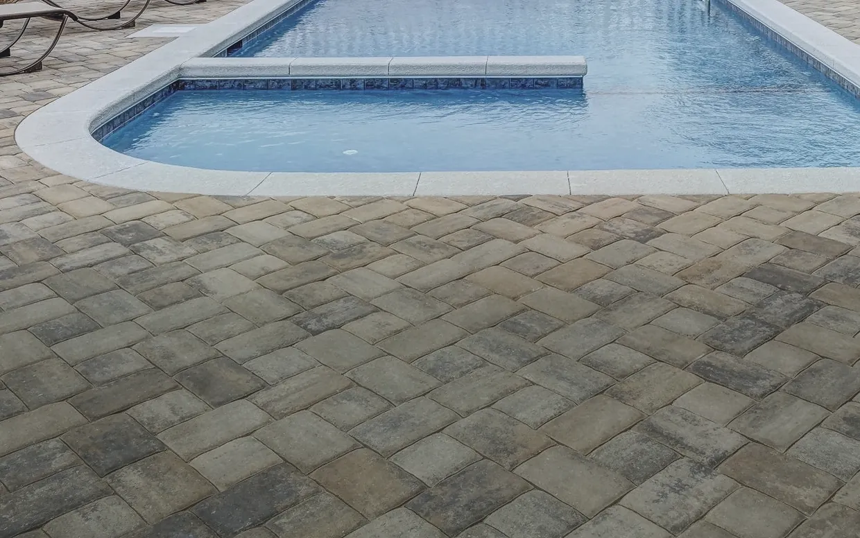 Paver pool surround shown weathered and then clean — before