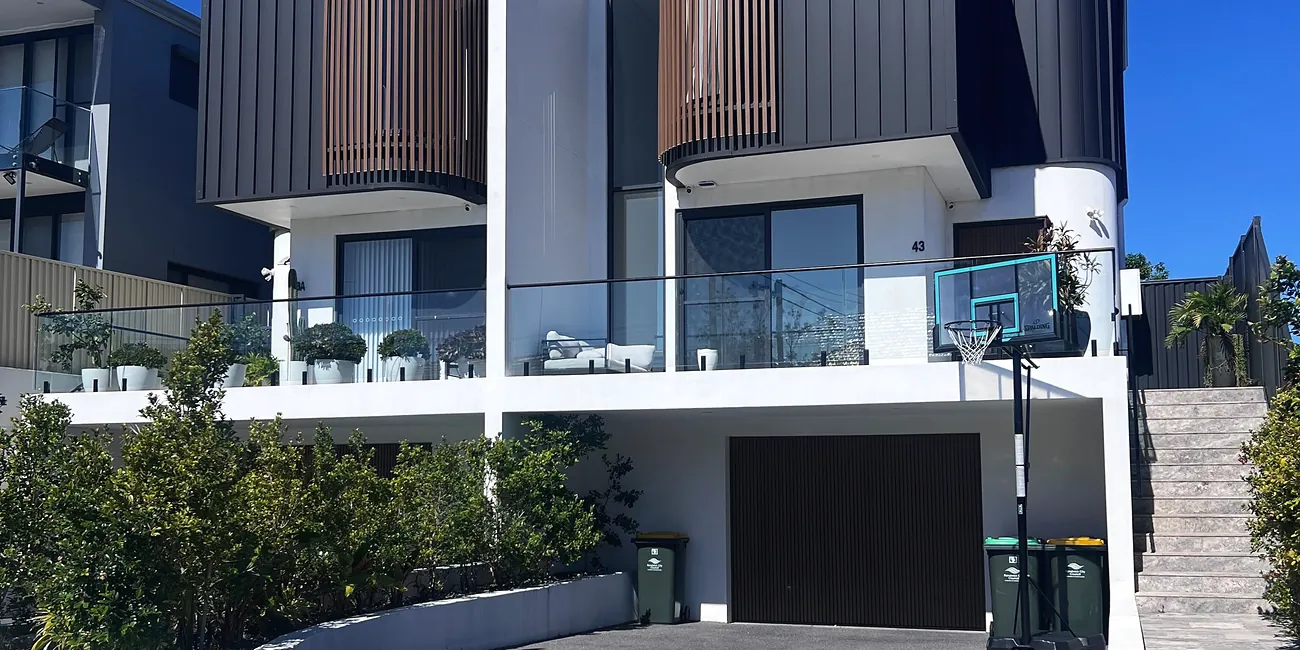 Contemporary Australian home with a concrete driveway and rendered facade