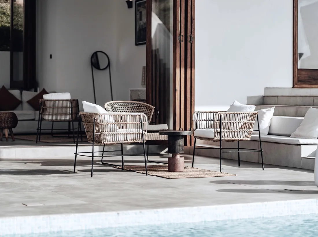 Modern poolside patio with outdoor furniture